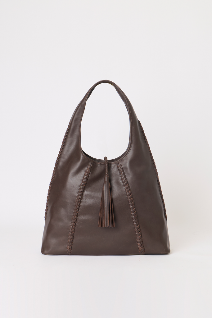 [color: chocolate leather] A dark brown leather shoulder bag with braided trim and a tassel detail, photographed against a plain light gray background.