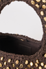 Close-up of a dark brown woven handbag with gold-tone studs and a black interior lining featuring a debossed logo patch.