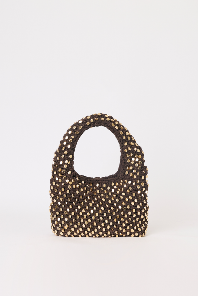 A small structured handbag covered in metallic gold studs on a dark brown base, featuring a single top handle, photographed against a plain white background.