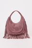 [color: eggplant suede] A dusty rose suede crescent-shaped shoulder bag with long fringe detailing along the bottom and sides, set against a plain light gray background.