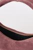 [color: eggplant suede] Close-up of a dusty rose suede shoulder bag with a gold zipper and a black interior lining featuring a debossed 'BTB' logo.