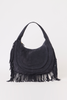 [color: navy suede]A navy suede crescent-shaped shoulder bag with long fringe detailing along the bottom and sides, photographed against a plain white background.