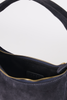 [color: navy suede] Close-up of the interior of a dark navy blue suede shoulder bag with gold-tone zippers and a black leather interior label.