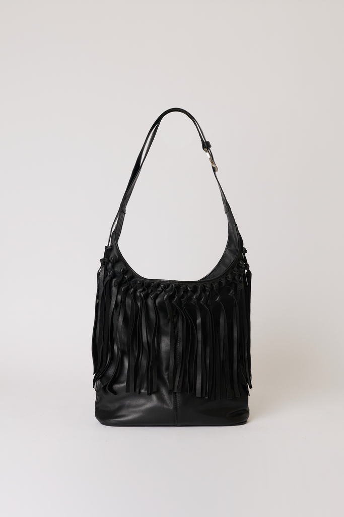 [color:black leather] A black leather shoulder bag with a long strap and a prominent fringe detail cascading from the top, photographed against a neutral light gray background.