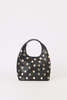 A black leather shoulder bag with a curved top handle, decorated with numerous gold-tone circular studs, shown against a plain white background.