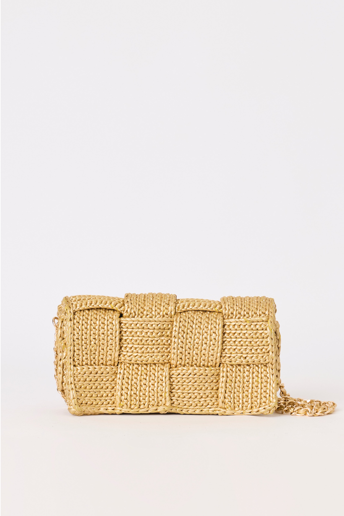 [COLOR: GOLD] A woven straw clutch bag in a natural light tan color, featuring a textured basketweave pattern and a thin woven strap, set against a plain white background.