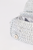 [COLOR: SILVER] Close-up of a silver metallic woven clutch bag with a silver satin lining and a small round metal snap button, set against a plain white background.