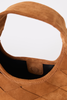 Close-up of a tan suede shoulder bag with a quilted pattern and a black interior lining, set against a plain white background.