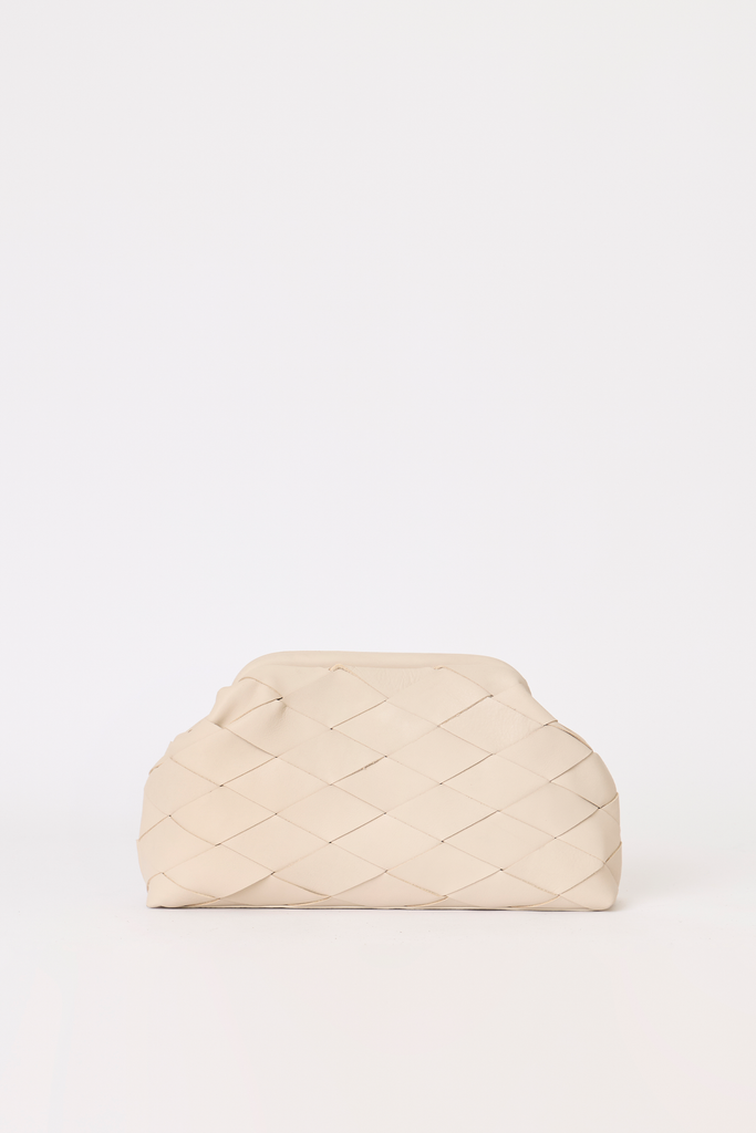 Woven leather cream leather clutch against a beige backdrop