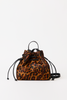 A leopard print mini backpack with black leather straps and a drawstring closure, photographed against a plain white background.