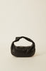 A black leather slouchy shoulder bag with a knotted handle, photographed against a solid off-white background.