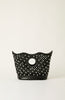 A black leather handbag with a scalloped top edge, a circular cutout handle, and an all-over pattern of white pearl-like studs, photographed against a plain off-white background.