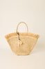 Woven handbag with fringes on a beige background