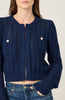 Navy blue knitted cardigan worn by a person on a plain background