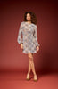 Woman wearing a patterned dress against a red background