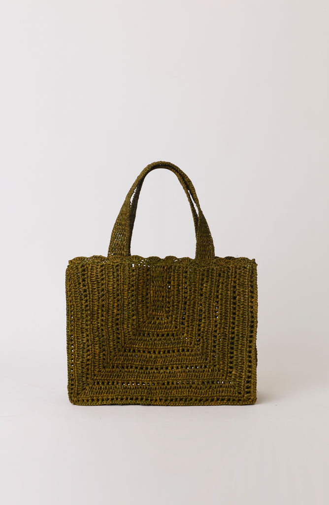 Green woven handbag on a white background